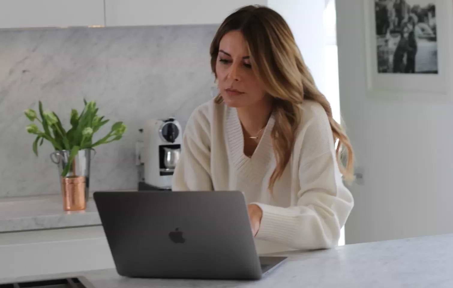 Stressed woman at computer showing impact of stress on skin