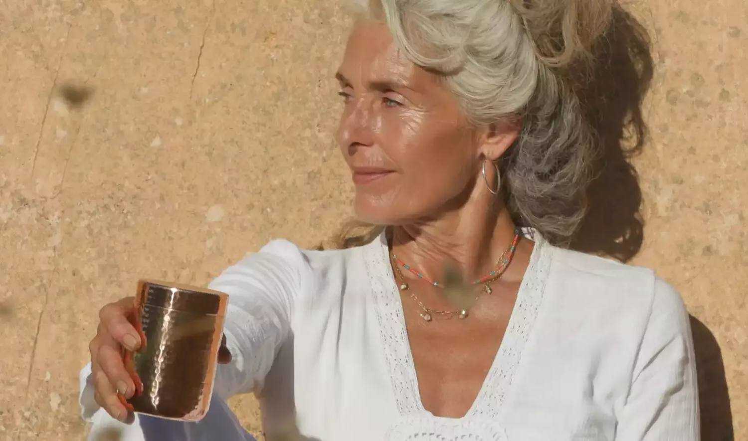 menopausal lady holding supplement
