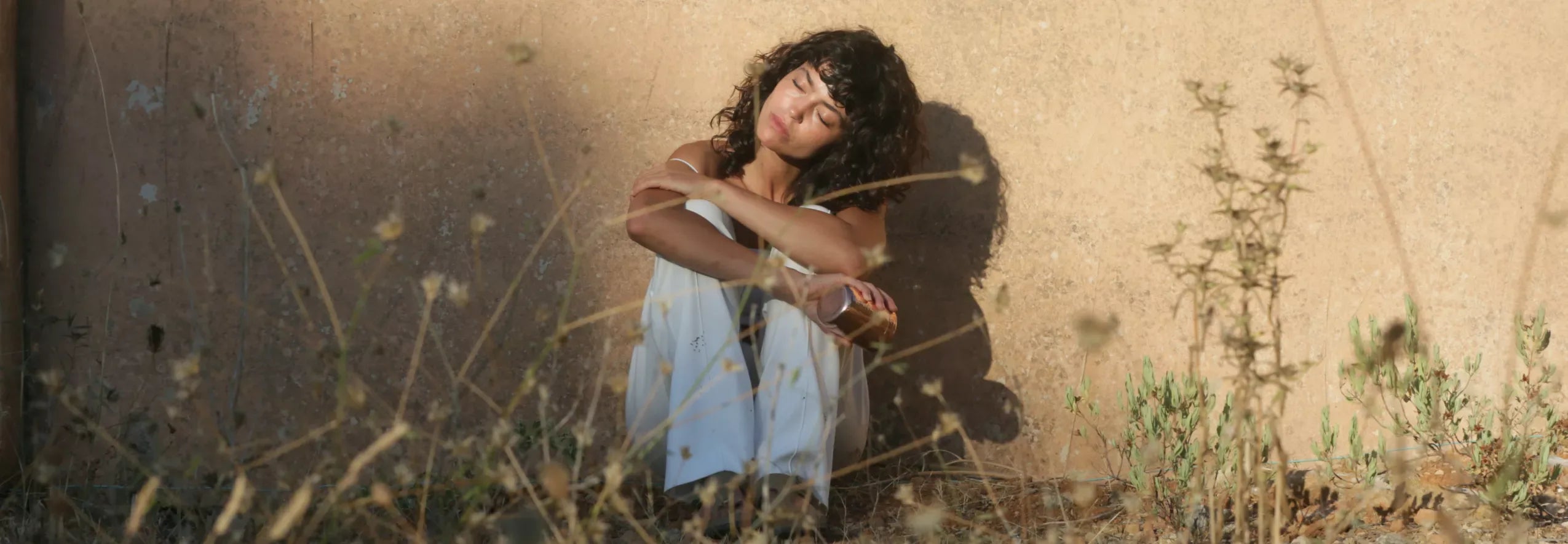 woman napping against a wall