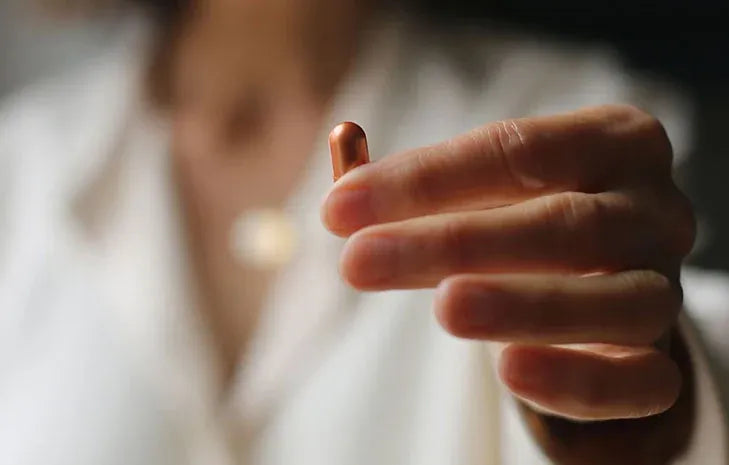 Supplement woman holding supplement balance your hormones