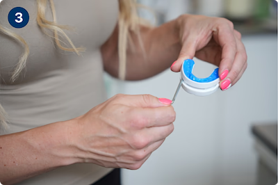 Hands holding the VitalSleep mouthpiece and the adjustment key