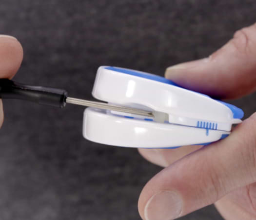 Turning the adjustment screw on the VitalSleep mouthpiece