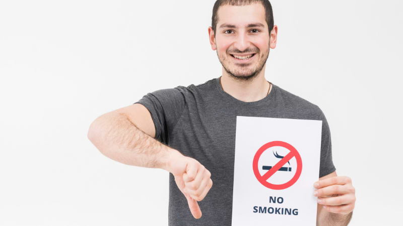 man holding stop smoking  sign