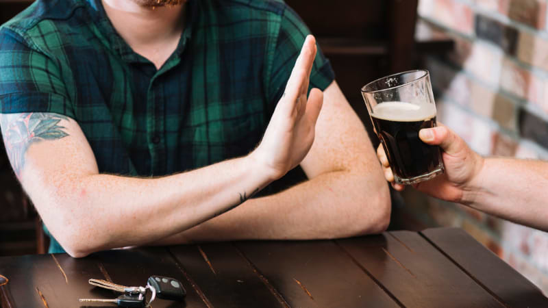 man refusing alcoholic drink