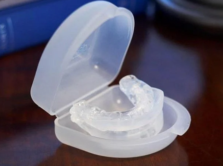 PureSleep anti-snoring mouthpiece shown with its storage case