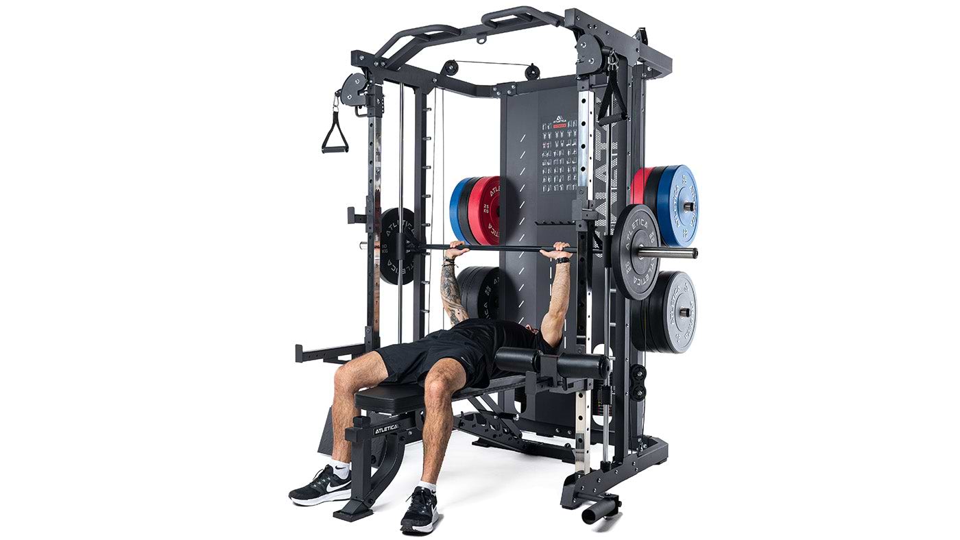 Man doing bench press on the Atletica SWAT Smith machine