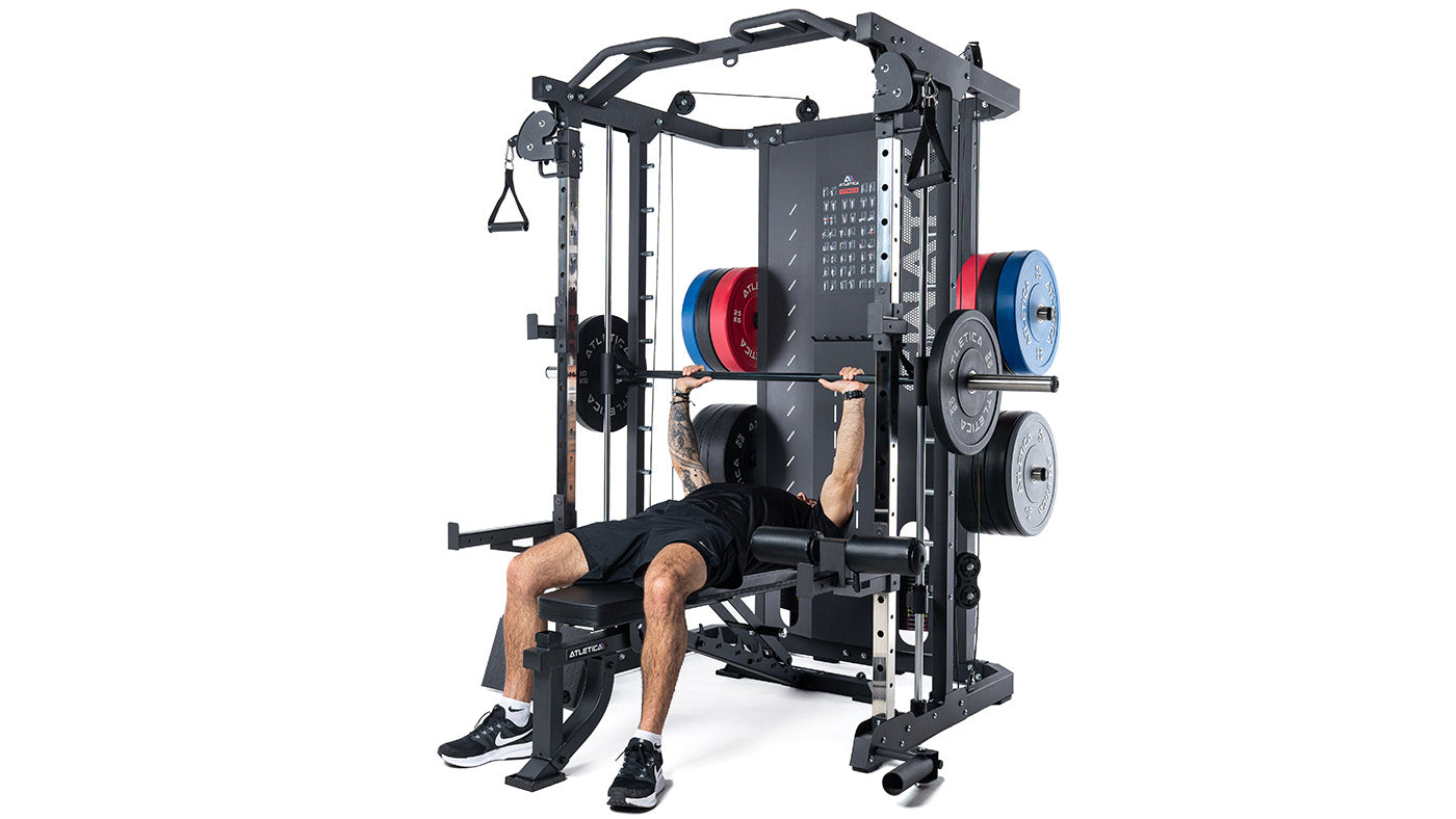 Man doing bench press on the Atletica SWAT Smith machine
