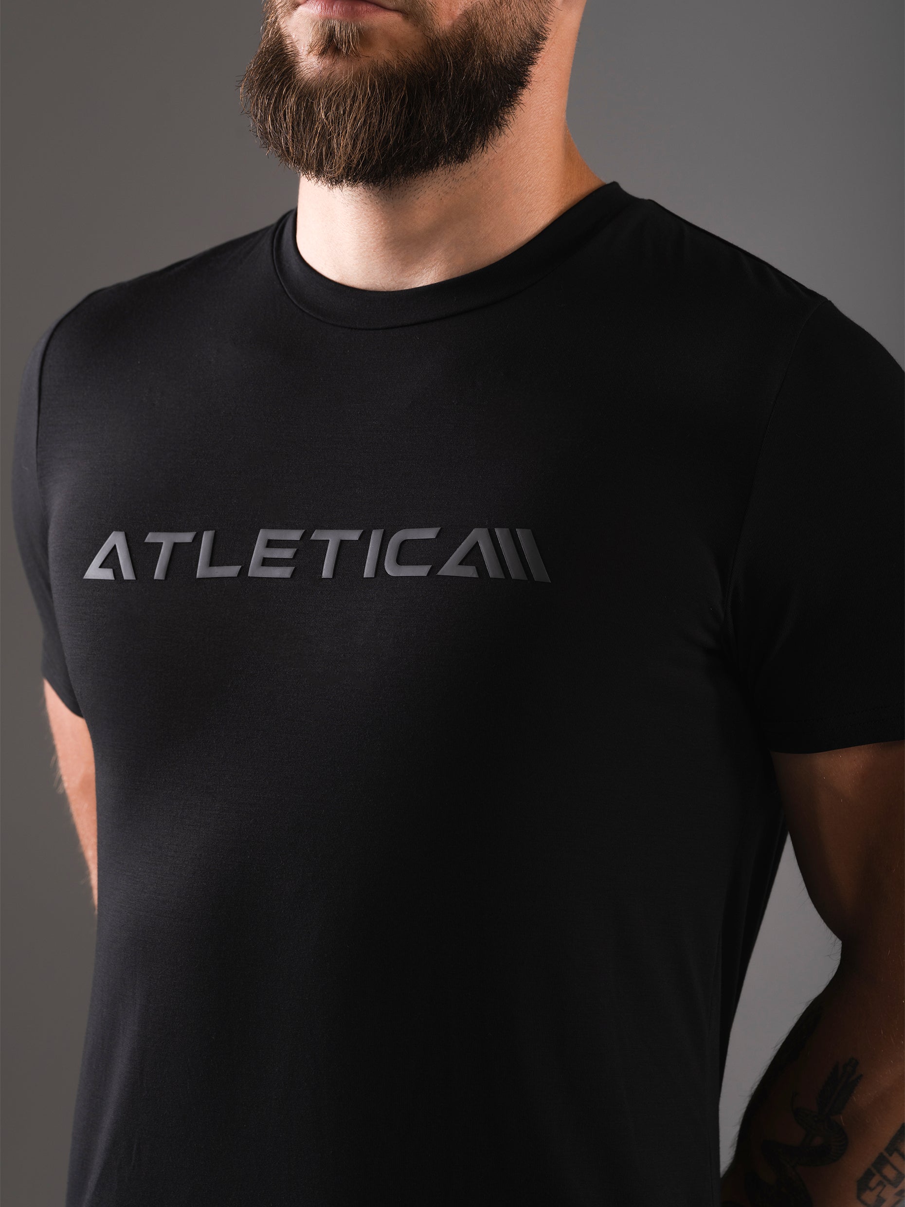 Nahaufnahme des Logo-Prints auf der Brust am schwarzen Merch Flex Train T-Shirt von Atletica