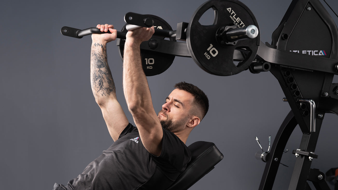 Atleet doet schouderdrukken aan het X-Tron multistation