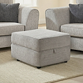 Thornby Storage Footstool Light Grey Charcoal from Roseland Furniture in a living room with the arm of a sof aon either sie, the room has white walls and light oak flooring covered by a cream rug.