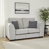 Thornby 2 Seater Sofa Light Grey Charcoal from Roseland Furniture in a living room adjacent to a window in a lounge with white walls and light oak flooring with a cream colour rug. to the right is a back side table and a tree and above is an abstract painting.