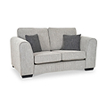 Thornby 2 Seater Sofa Light Grey Charcoal from Roseland Furniture postitioned at an angle highlighting the black legs and textured details of the sofa with simple piping around the edges and two grey cushions.