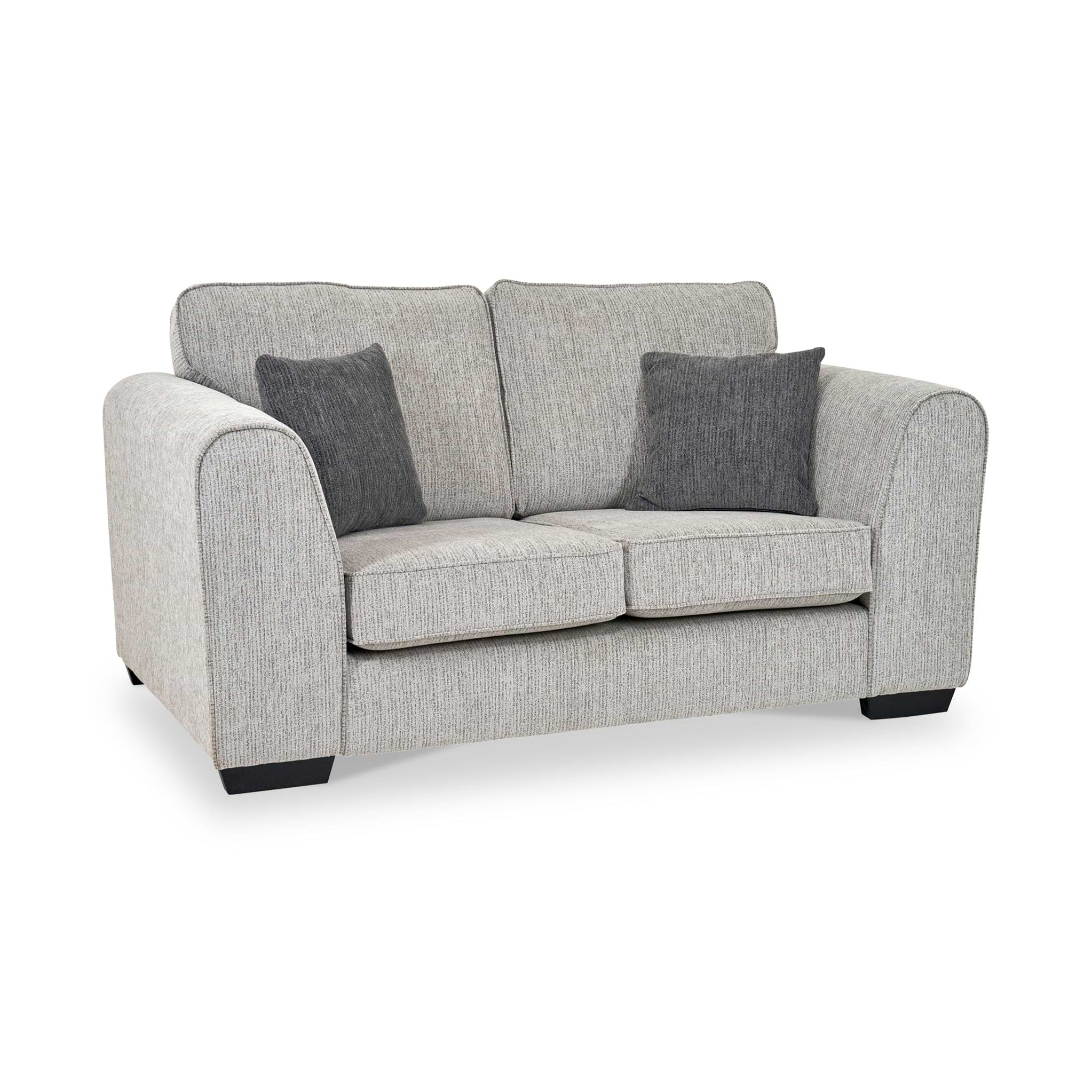 Thornby 2 Seater Sofa Light Grey Charcoal from Roseland Furniture postitioned at an angle highlighting the black legs and textured details of the sofa with simple piping around the edges and two grey cushions.