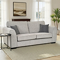 Thornby 3 Seater Sofa Light Grey Charcoal from Roseland Furniture in a living room with two french doors behind. on the right is a plant and on the white walls is a painting, the flooring is a light oak and is covered with a cream rug. 