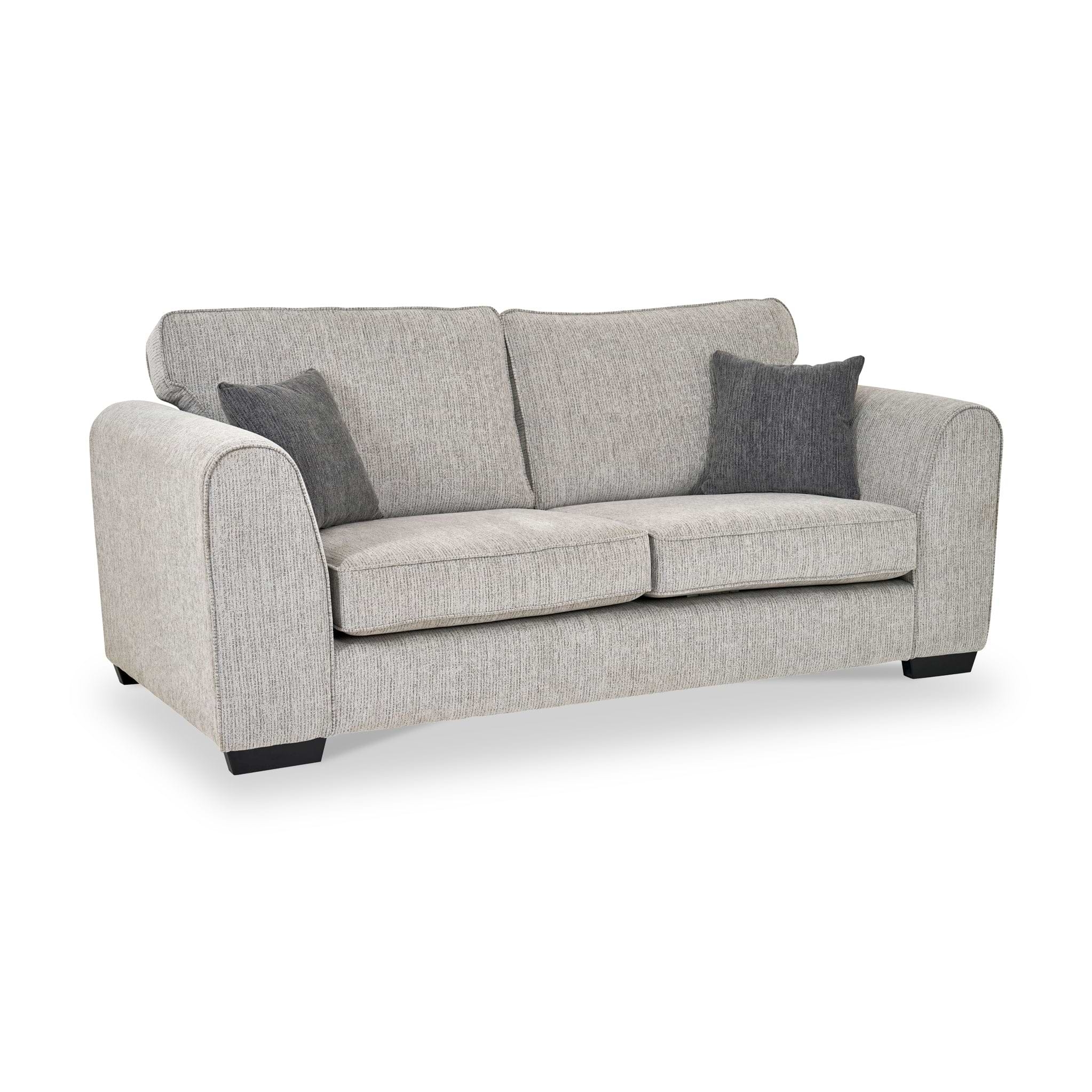 Thornby 3 Seater Sofa Light Grey Charcoal from Roseland Furniture postitioned at an angle highlighting the black legs and textured details of the sofa with simple piping around the edges and two grey cushions.