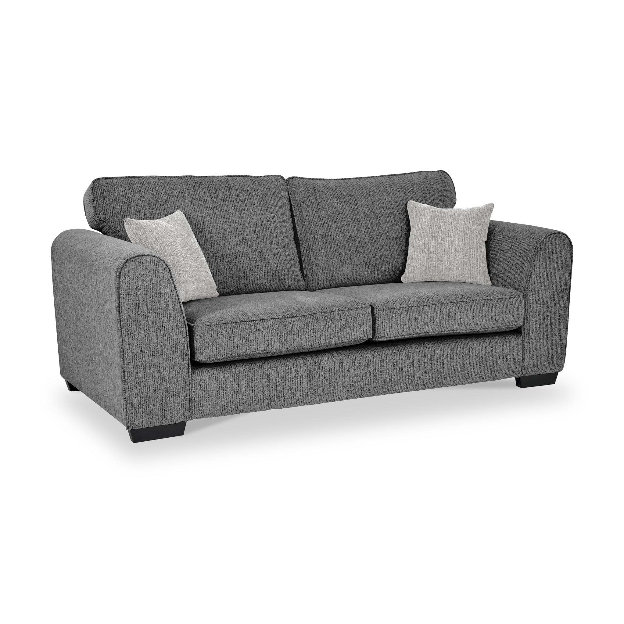 Thornby 3 Seater Sofa Charcoal Light Grey from Roseland Furniture postitioned at an angle highlighting the black legs and textured details of the sofa with simple piping around the edges and two cream cushions.