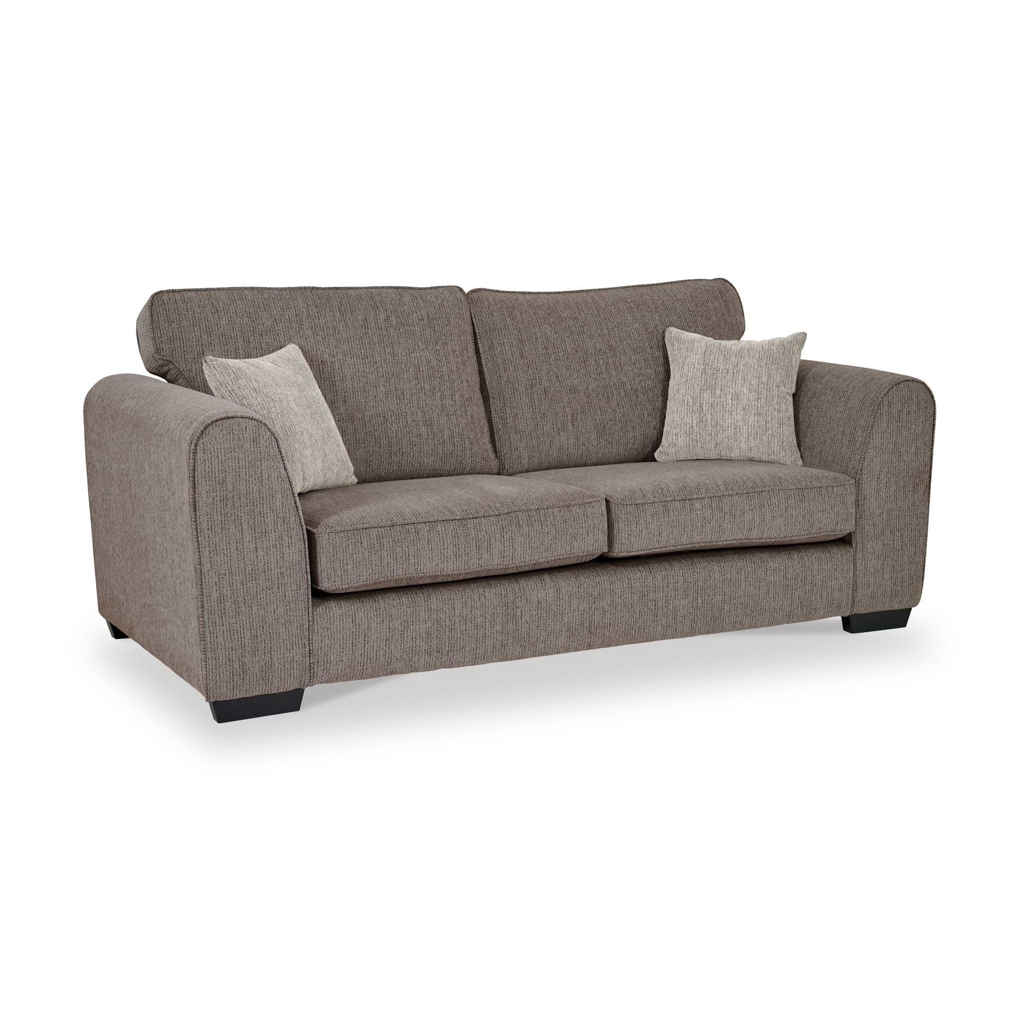 Thornby 3 Seater Sofa Mink Natural from Roseland Furniture postitioned at an angle highlighting the black legs and textured details of the sofa with simple piping around the edges and two mink cushions