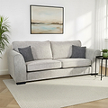 Thornby 4 Seater Sofa Light Grey Charcoal from Roseland Furniture in a living room positioned against a white wall below an abstract painting, side table on the right