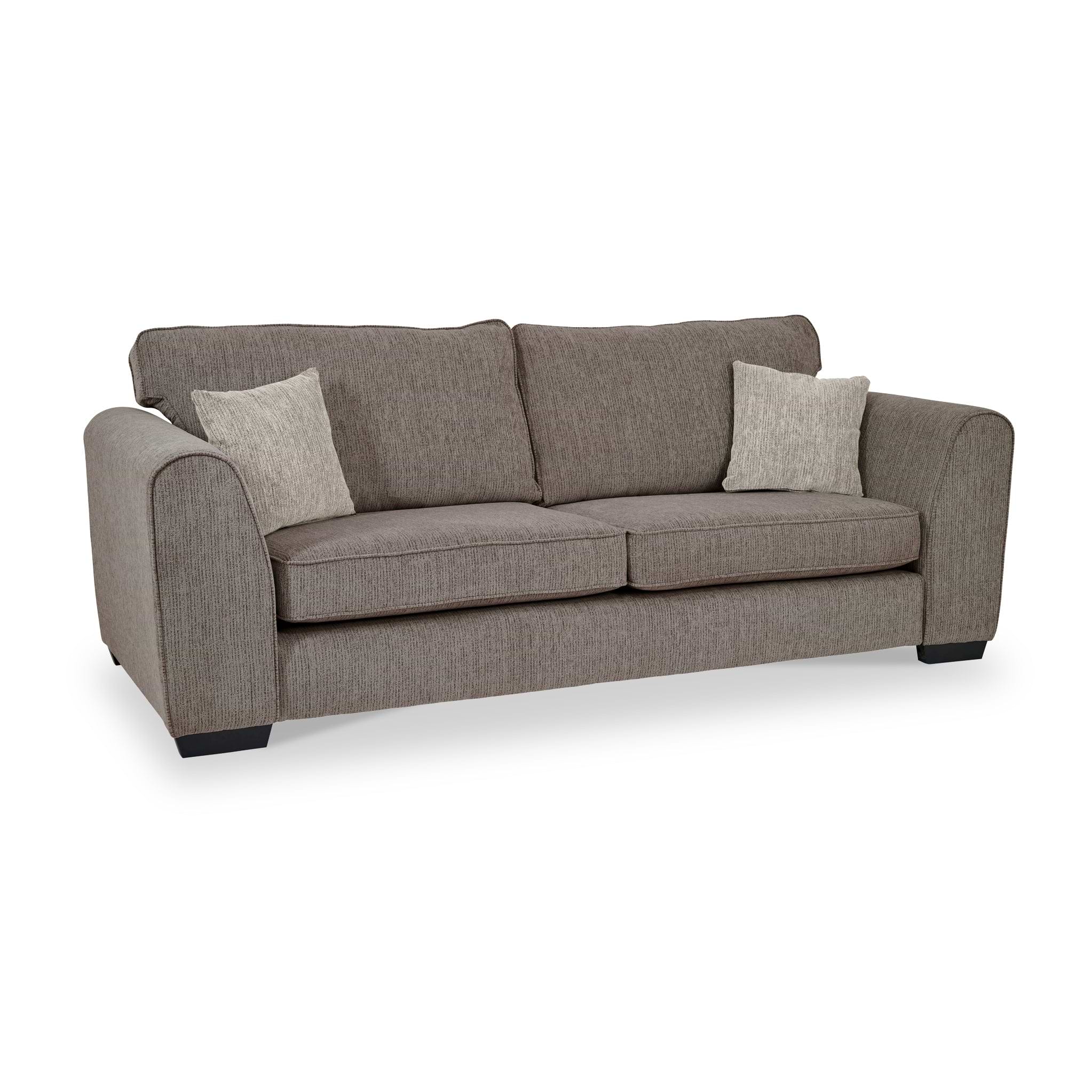 Thornby 4 Seater Sofa Mink Natural from Roseland Furniture postitioned at an angle highlighting the black legs and textured details of the sofa with simple piping around the edges and two mink cushions