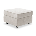 Thornby Standard Footstool Natural from Roseland Furniture positioned at an angle to display the black legs and the texture of the footstool