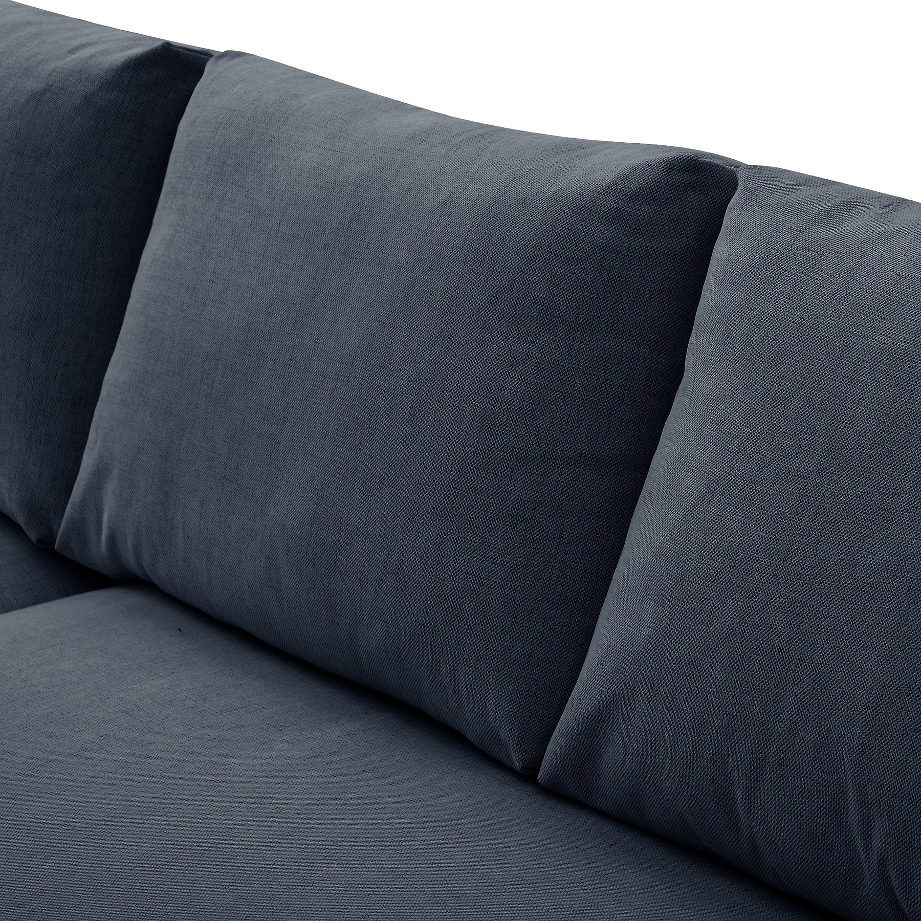 A grey fabric sofa with a cylindrical cushion resting on its surface, set against a neutral background.
