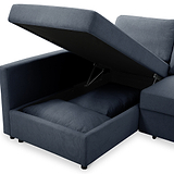 A blue sectional sofa with one seat lifted to reveal storage compartment; isolated against a white background.