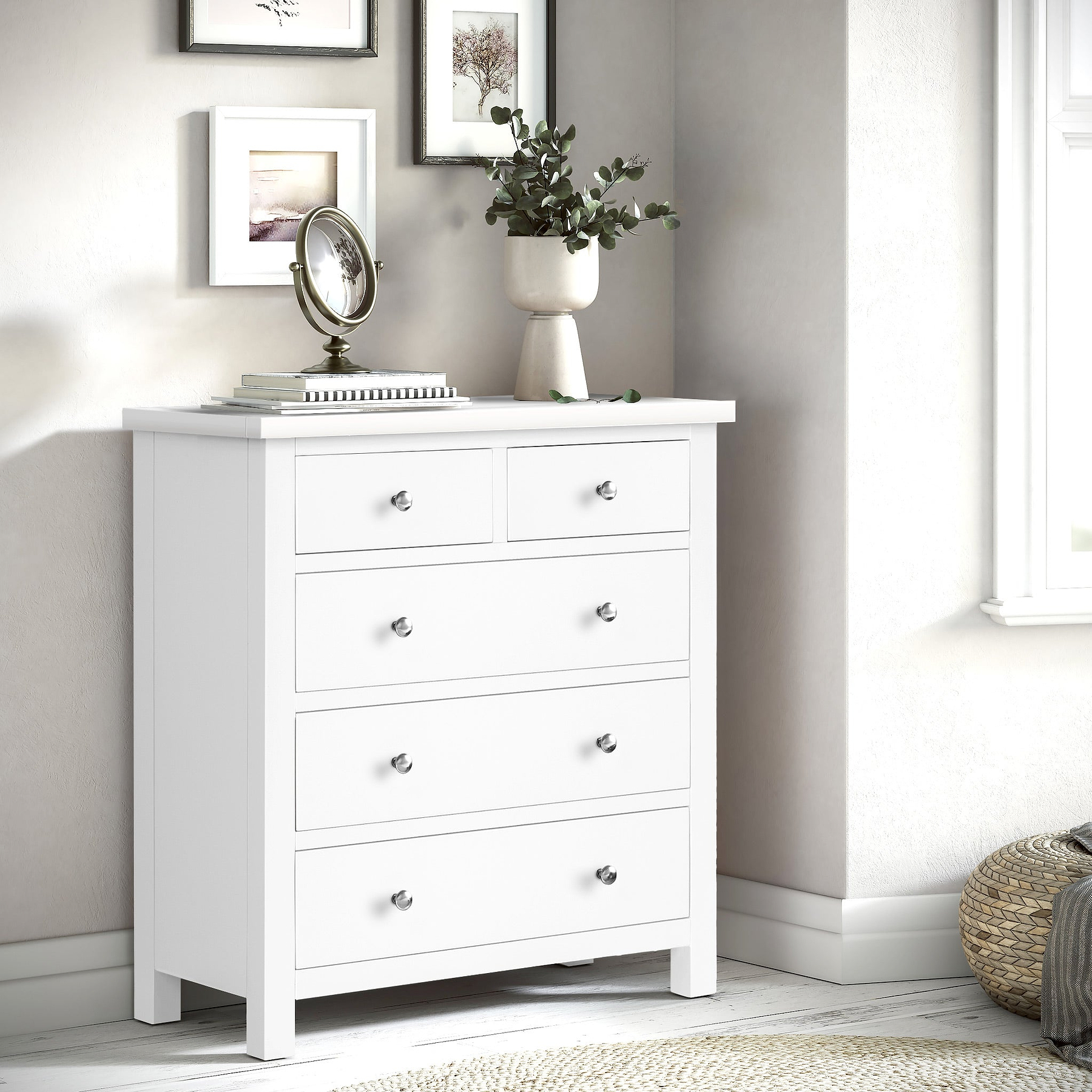 A white wooden dresser with seven drawers, each featuring a simple round knob, stands isolated against a plain background.