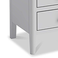 A white dresser with three drawers is partially visible, standing stationary against a plain background.