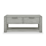 A wooden coffee table with two drawers and a lower shelf, featuring a light gray wood grain finish, presented against a white background.