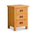 A wooden three-drawer bedside table with round metal handles, set against a white background.