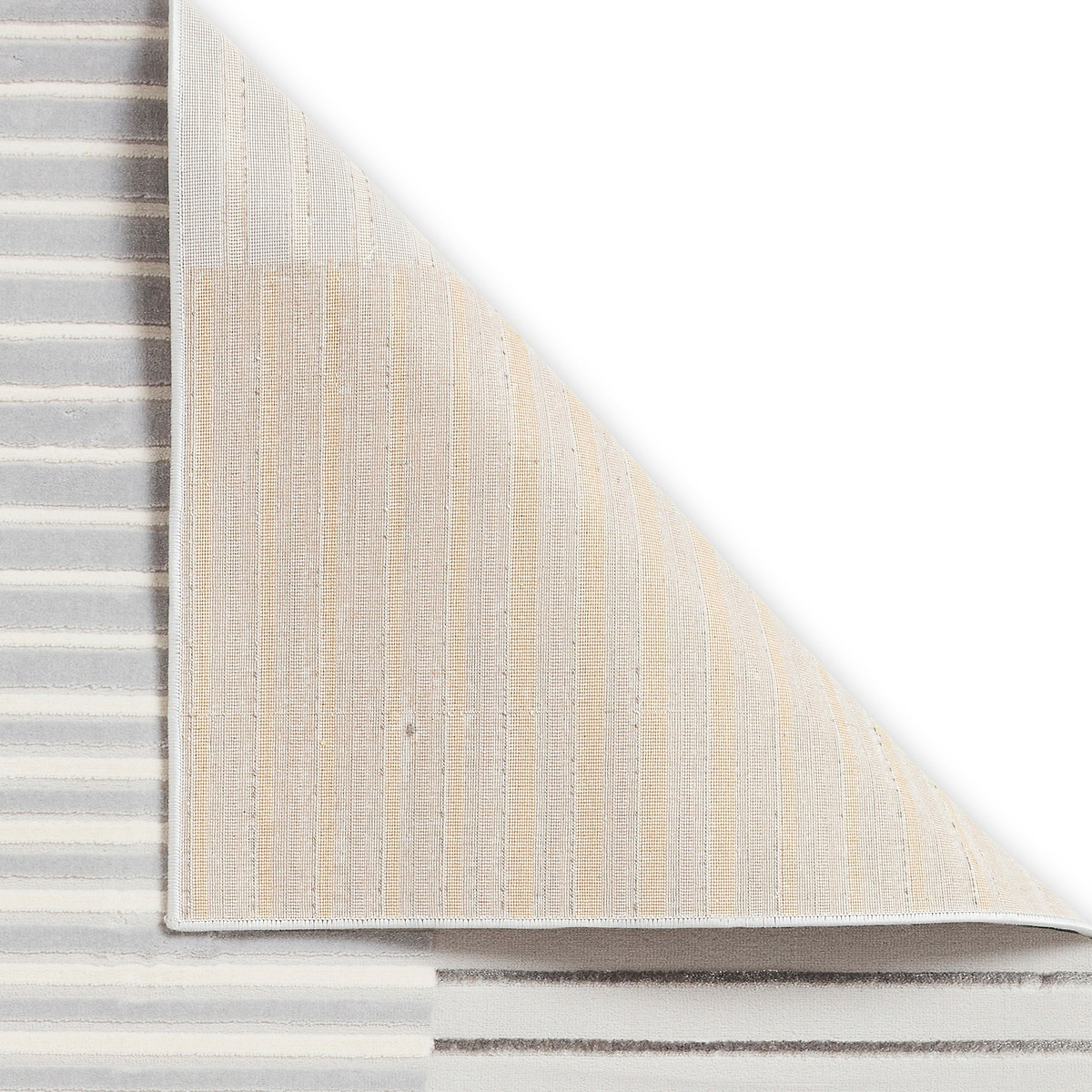 A corner of a layered, textured rug lifted to reveal its underside, highlighting the striped fabric and weave against a plain white background.