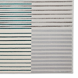 A patterned rug is displayed with alternating stripes in teal, brown, and shades of gray, creating a textured visual effect against a neutral background.