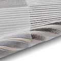 A stack of woven textiles with varying shades of grey and white, creating a gradient effect from light to dark, displayed against a neutral background.