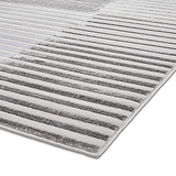 A striped gray and white rug on a white background, showcasing a partial view with an emphasis on texture and pattern.