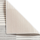 A beige carpet partially rolled up, revealing a striped pattern underneath, isolated on a white background.