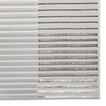 A rug with alternating light and dark stripes lies flat, presenting a textured visual pattern.