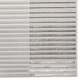 A rug with alternating light and dark stripes lies flat, presenting a textured visual pattern.