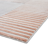 Striped rug with alternating beige and gray bands laid flat on a white surface, viewed at an angle.