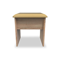 A small wooden desk with a tan cushioned top stands isolated against a white background.
