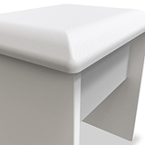 A white padded bench with a smooth finish is depicted, set against a monochromatic background enhancing its minimalistic design.