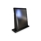 A black digital tablet is propped upright by its stand on a white surface against a white background, showcasing a blurred screen.