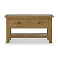 A wooden coffee table with two drawers and a lower shelf, isolated on a white background.