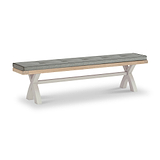 A cushioned wooden bench with white crisscross legs, shown stationary against a plain white background.