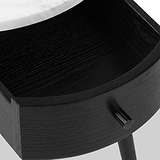 Close-up of a Shorwell Black & Marble 1 Drawer Side Table drawer with a curved front, a small round black knob, and part of a white marble tabletop visible at the top edge.