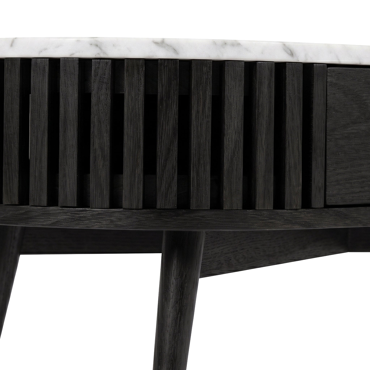 Close-up of a modern Shorwell Black & Marble 1 Drawer Oval Coffee Table from Roseland Furniture with a white marble top, featuring vertical slats on the front and tapered legs, shown against a white background.