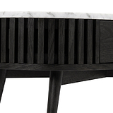 Close-up of a modern Shorwell Black & Marble 1 Drawer Oval Coffee Table from Roseland Furniture with a white marble top, featuring vertical slats on the front and tapered legs, shown against a white background.