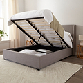 Brent Ottoman Storage Bed Frame from Roseland Furniture- Gray upholstered bed with raised headboard in a bedroom setting