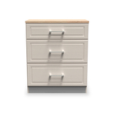 A three-drawer wooden filing cabinet with silver handles stands isolated against a white background.
