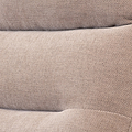 Folded beige fabric with a textured pattern, resting, likely a textile or garment in close-up view.