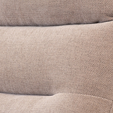 Three stacked, brown textured pillows with a zigzag pattern, resting against each other.